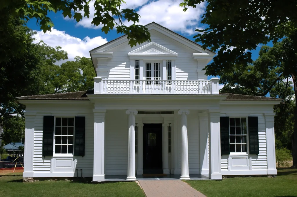 white home with a greek revival themed portico