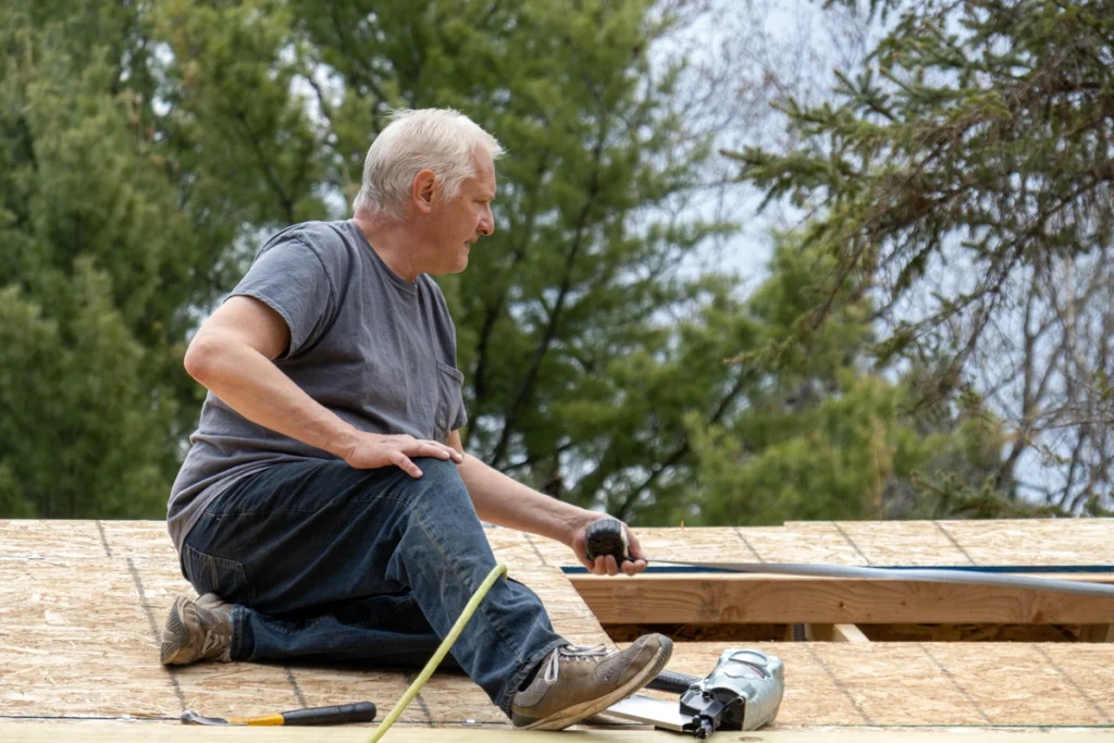 sitting and measuring a roof