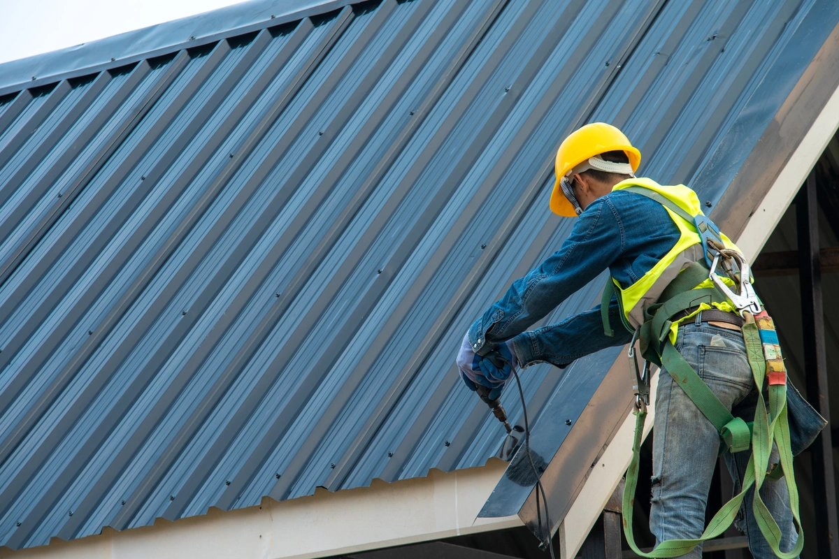 roofer installing a metal roof