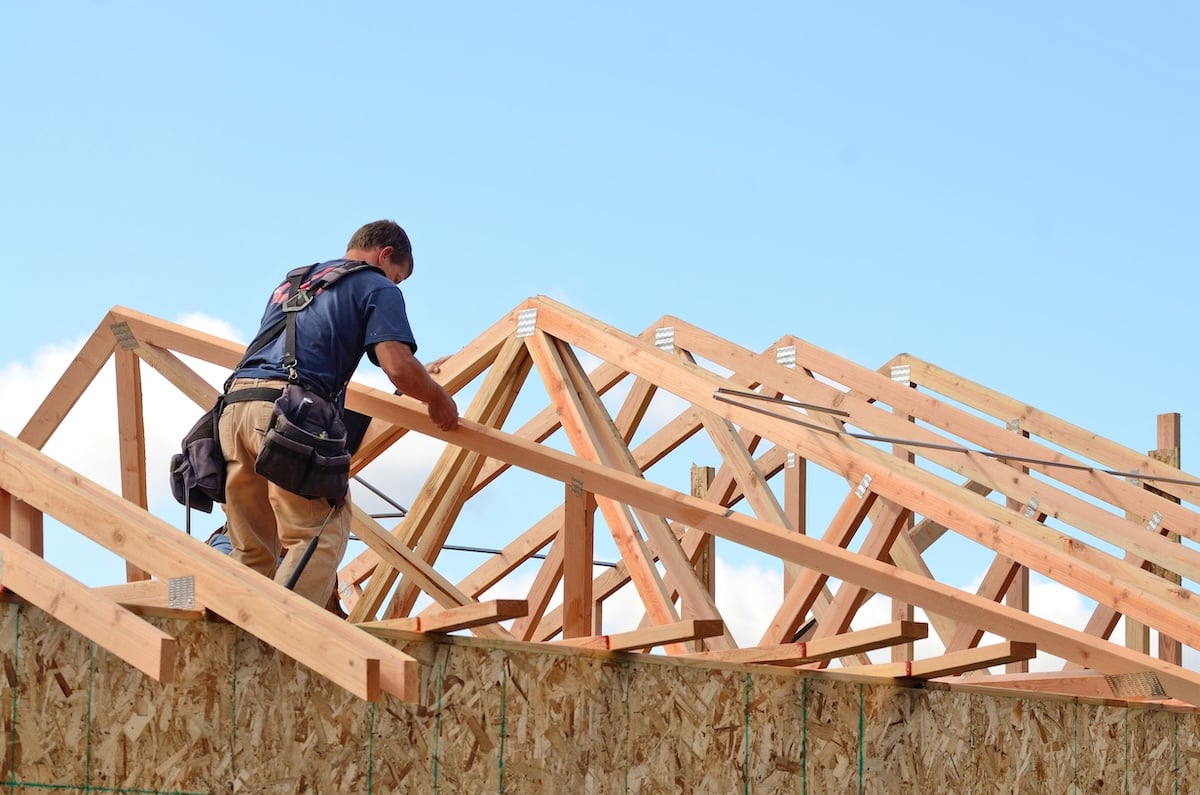Roofing contractor installing roof truss