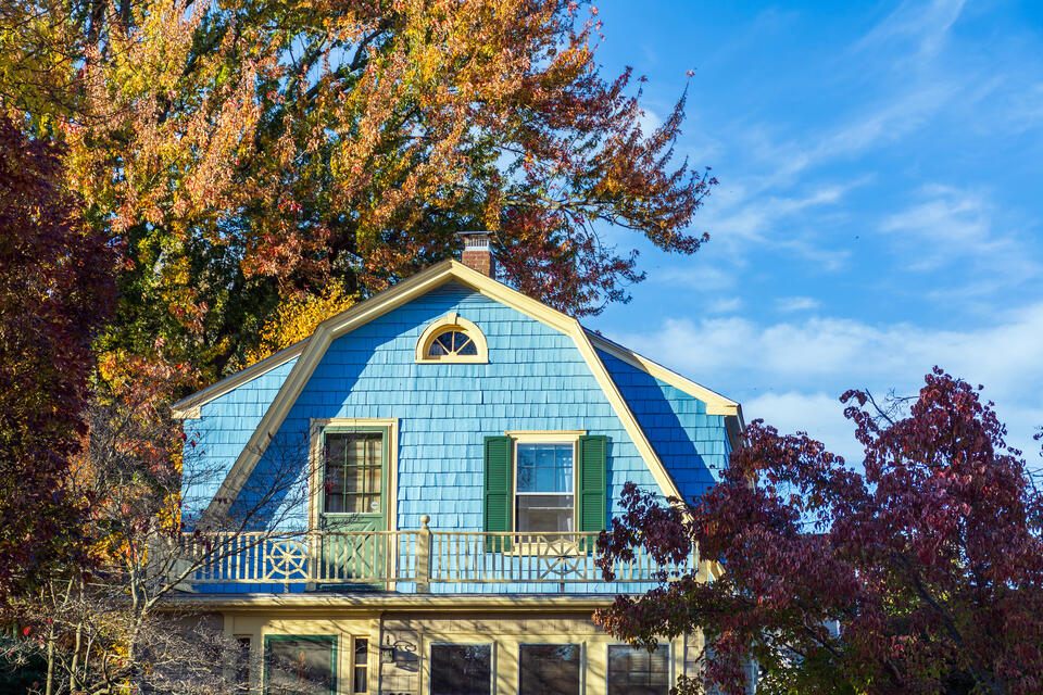 pitched roof-gambrel roof on a blue sided house