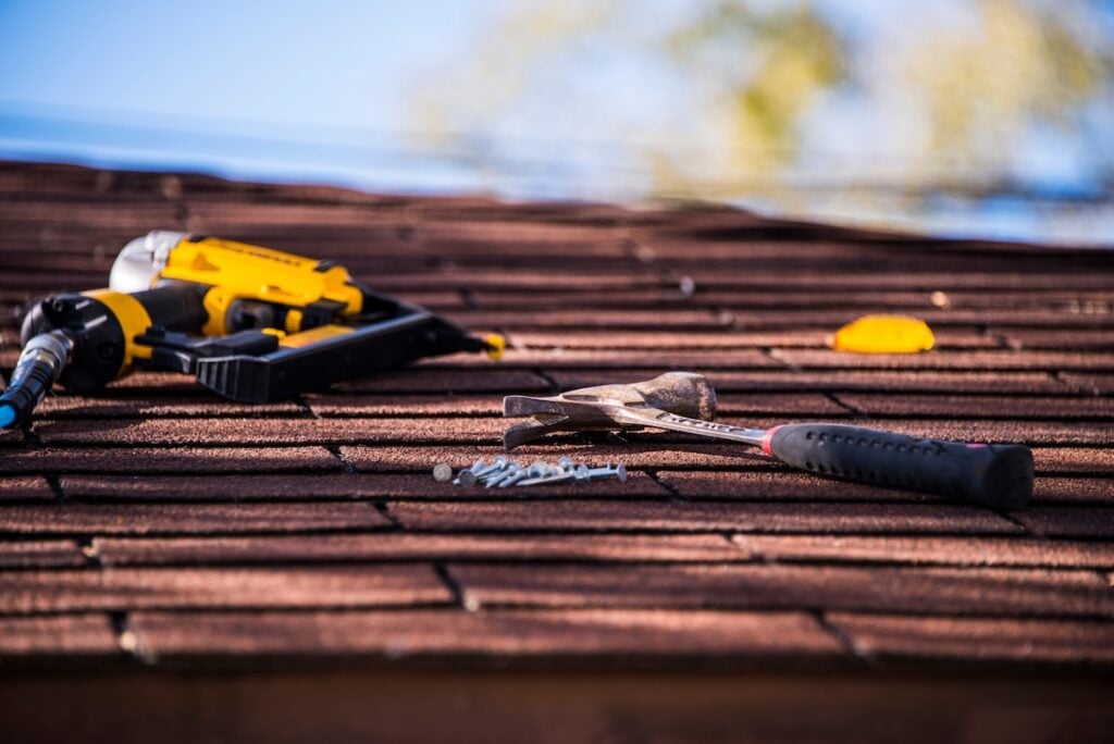Roofing tools on top of a asphalt shingle roof