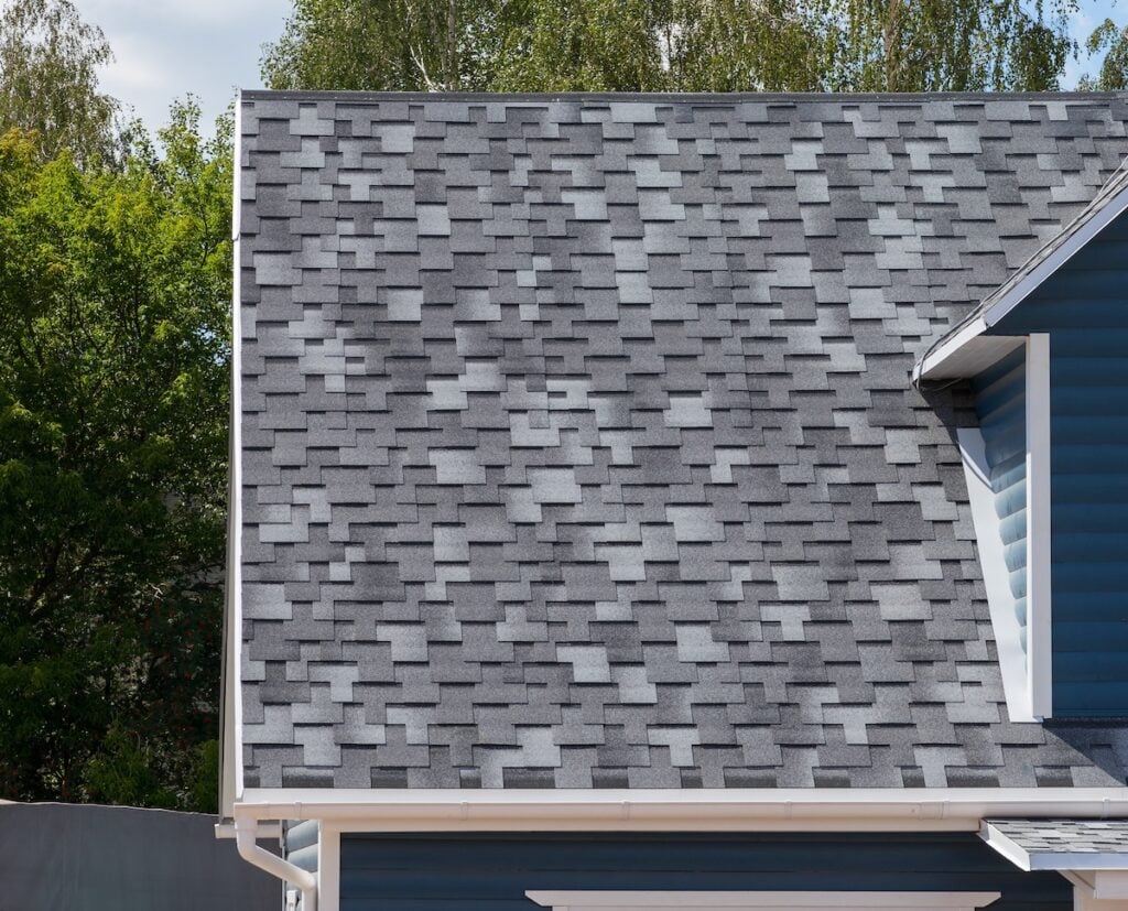The roof of the house lined with gray dimensional shingles