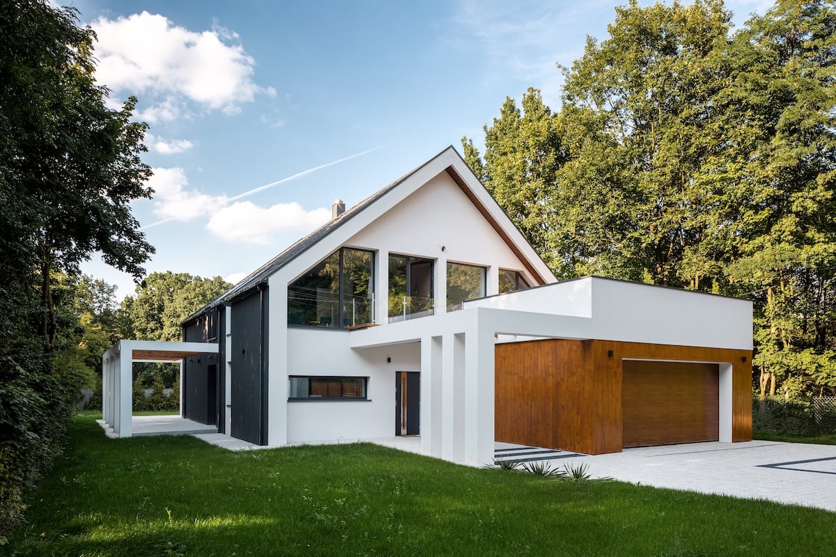 Exterior view of modern, white house with garage