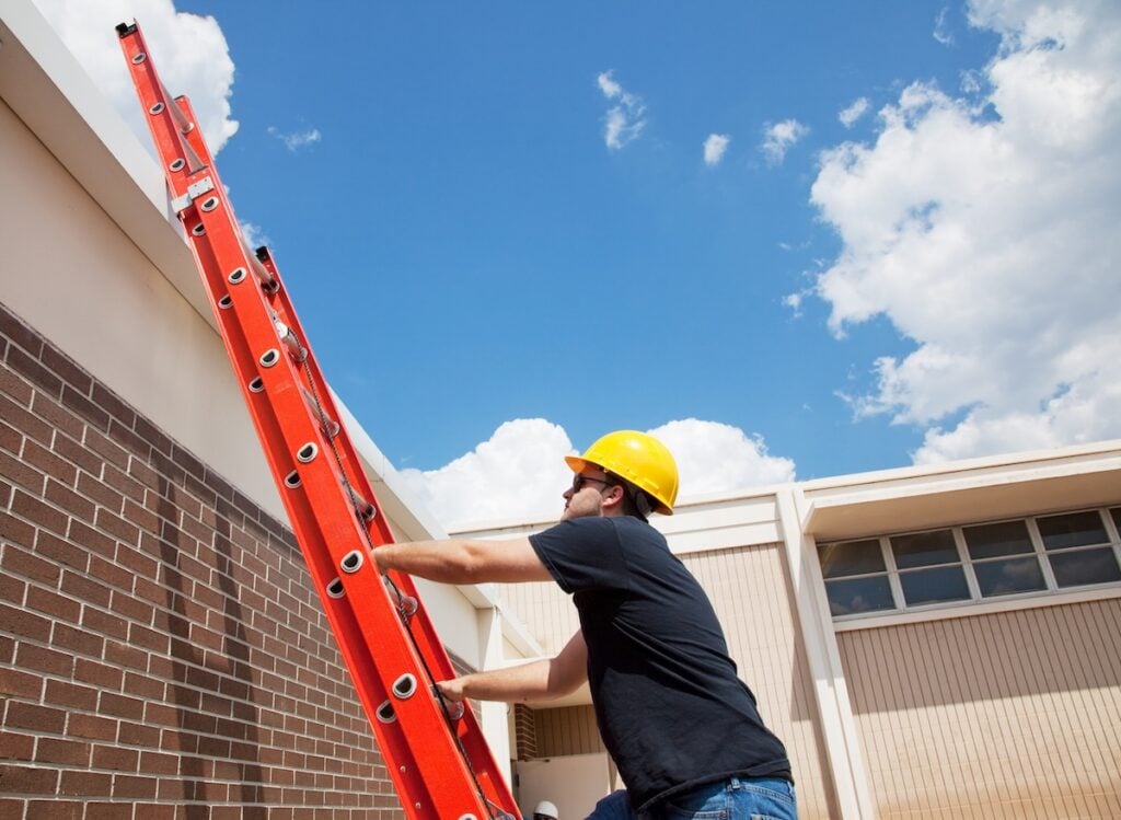 roofer climbing on a ladder
