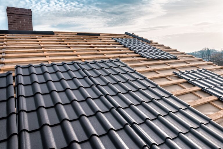Metal tile on the roof. Roof repairing