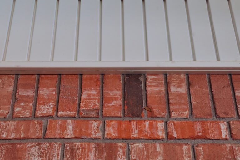 Orange bricks and white vinyl siding