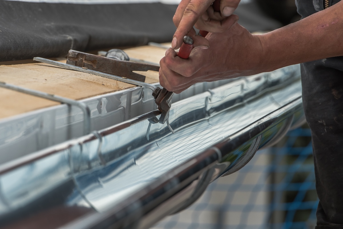 Close-up of a newly installed gutter on a roof.